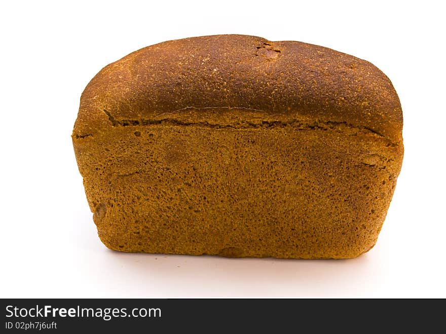 A loaf of fresh rye bread rectangular shape on a white background, top view. A loaf of fresh rye bread rectangular shape on a white background, top view