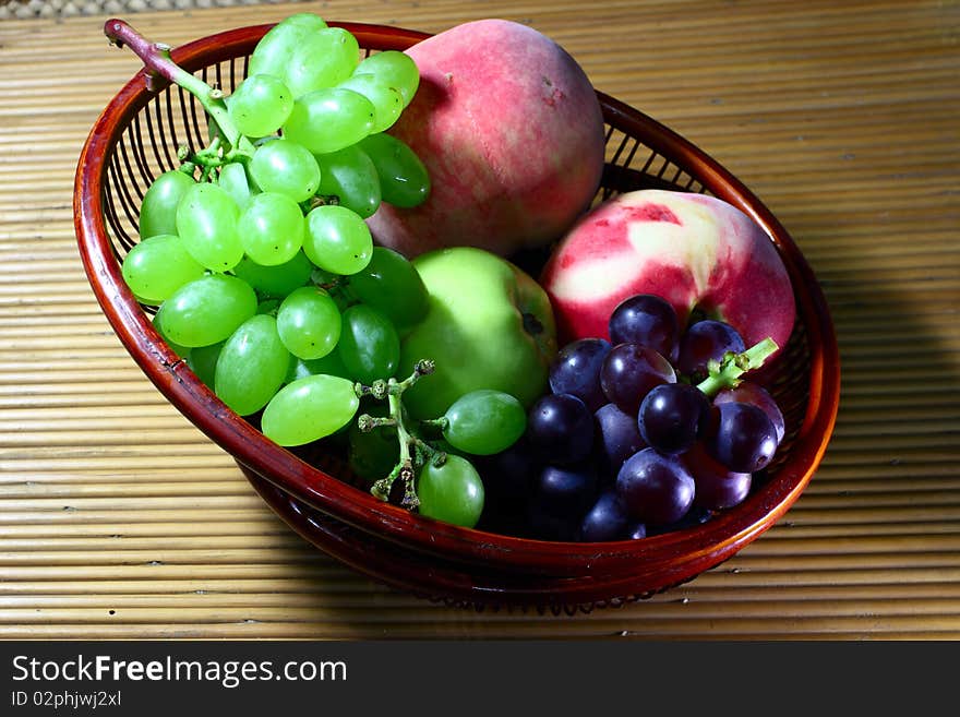 Group of different fruits  in the   bamboo tray.