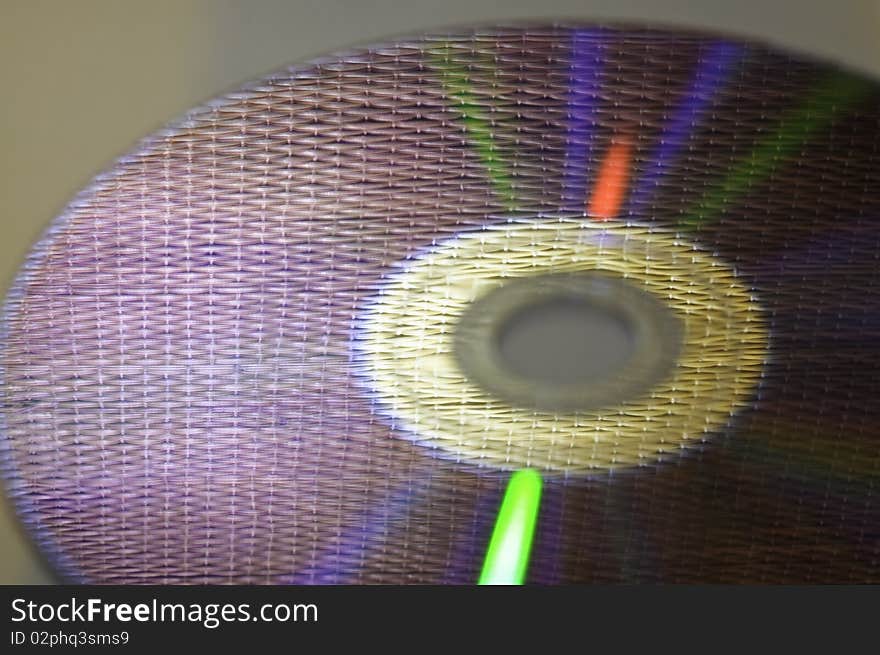 This picture shows a DVD with his reflection and glare in bright colors