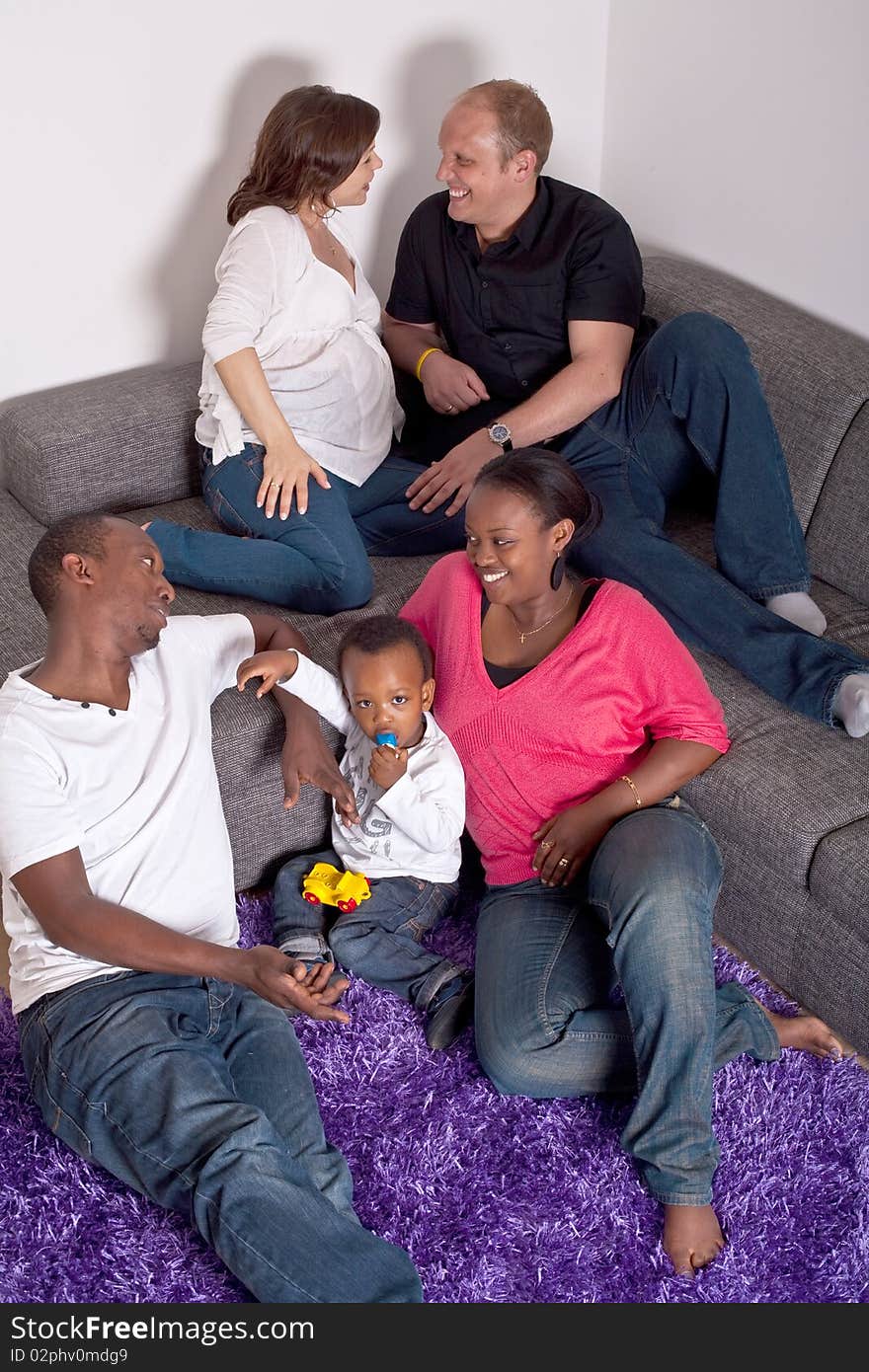 Young group of multiracial friends - two young families enjoying the afternoon. Young group of multiracial friends - two young families enjoying the afternoon.