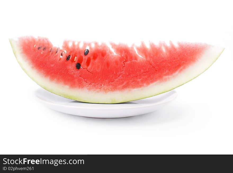 Slice of watermelon in plate close up isolated over white bacground. Slice of watermelon in plate close up isolated over white bacground