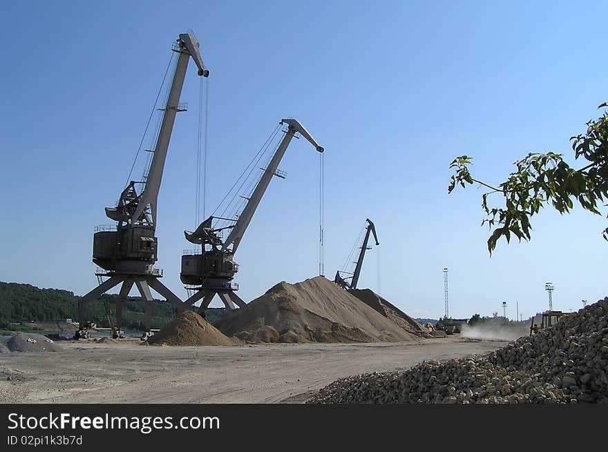 River port cranes, Oka river, Nizniy Novgorod, Russia. Industrial transportation of sand, gravel, etc.