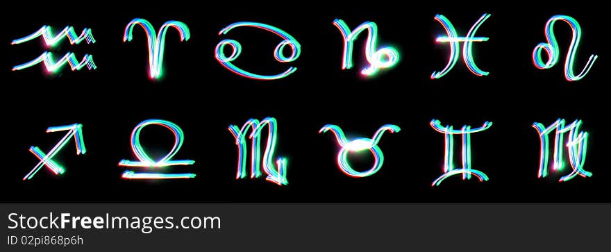 Signs of the zodiac on a black background. Freezelight. photography style