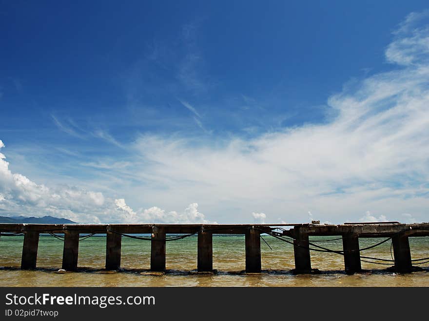 Tropical Beach Dock on a Blue Sky