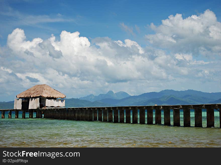 Tropical Beach Dock on a Blue Sky