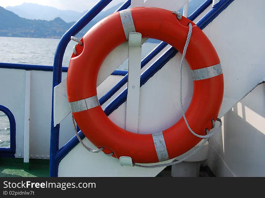 Orange lifebuoy ring on a ship