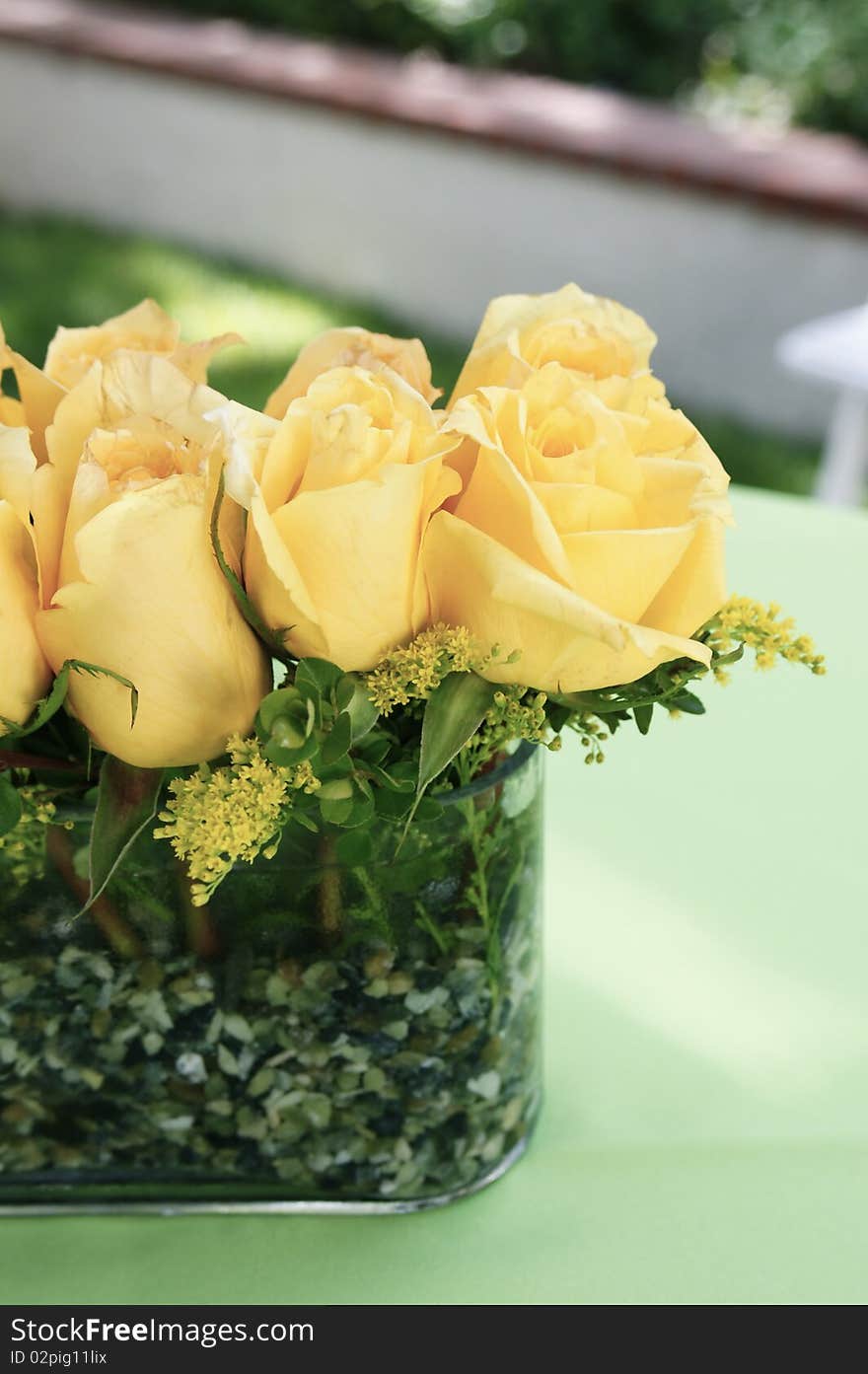 An arrangement of yellow roses in a vase. An arrangement of yellow roses in a vase