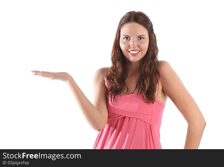 Smiling girl in pink dress presenting things isolated on white background