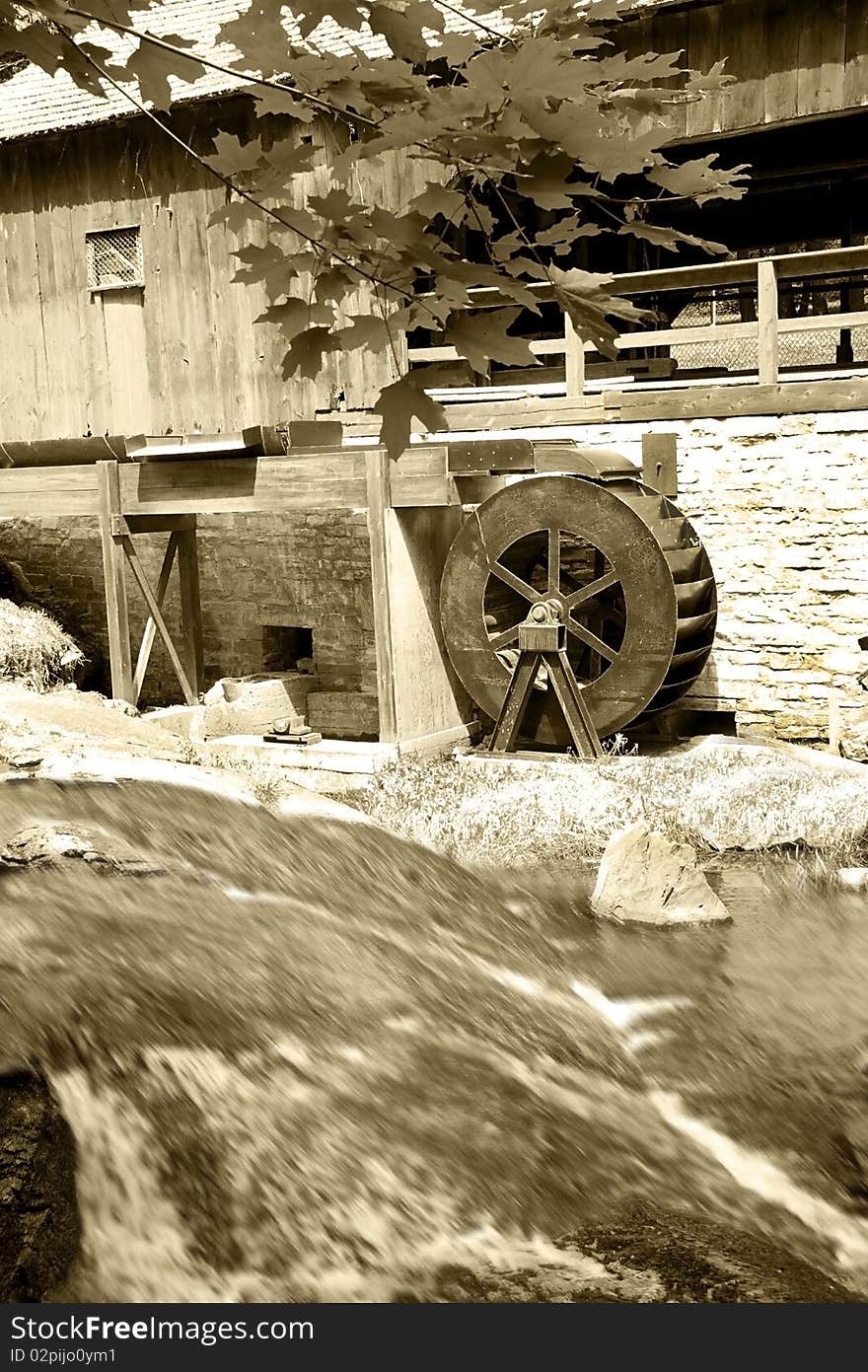 Old saw mill with water wheel and covered bridge.