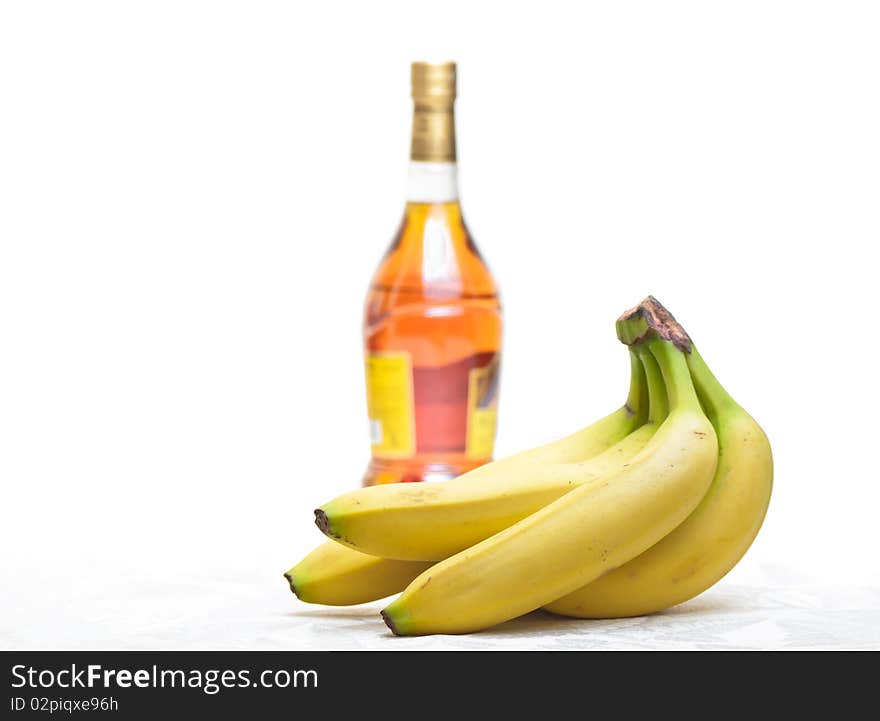 Bottle of  brandy and yellow banana isolated. Bottle of  brandy and yellow banana isolated