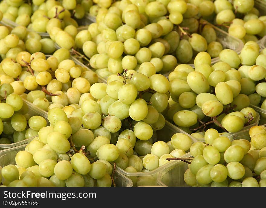 Fresh yellow grapes in baskets at market. Fresh yellow grapes in baskets at market