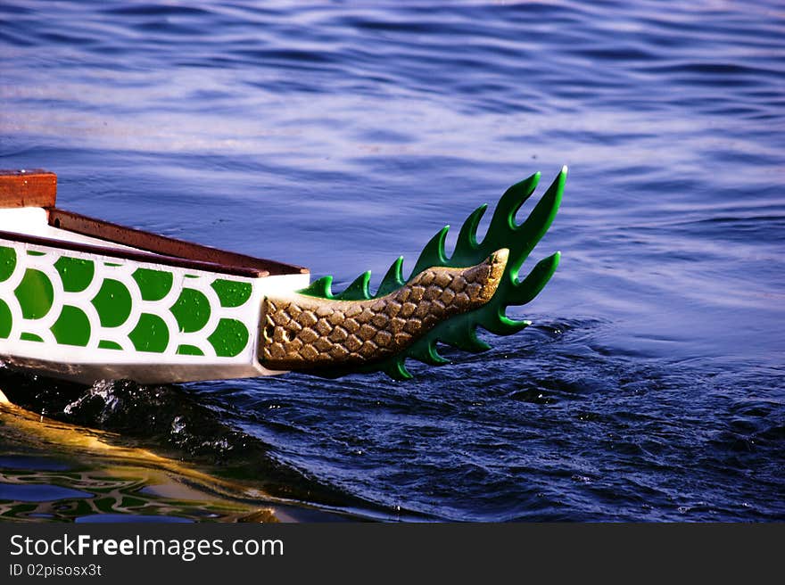 The dragon boat slips quietly through the water. The dragon boat slips quietly through the water