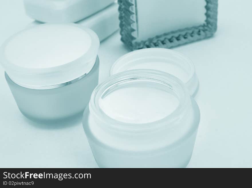 Containers of lotion and hand cream, and soap bars close-up. Containers of lotion and hand cream, and soap bars close-up.