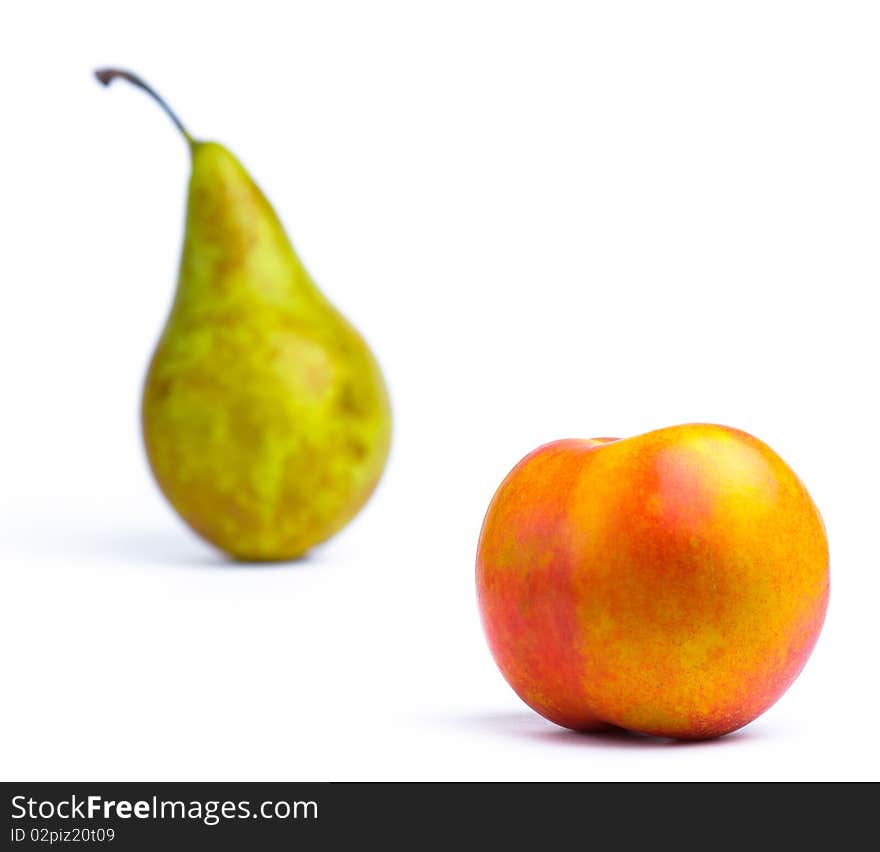 Horizontal image of isolated green pear and peach. Horizontal image of isolated green pear and peach