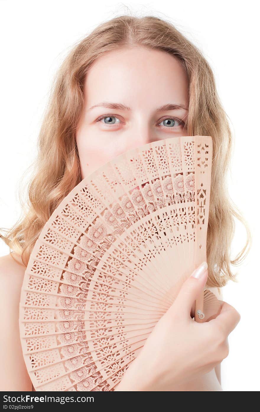 Beautiful young woman with a fan on a white background