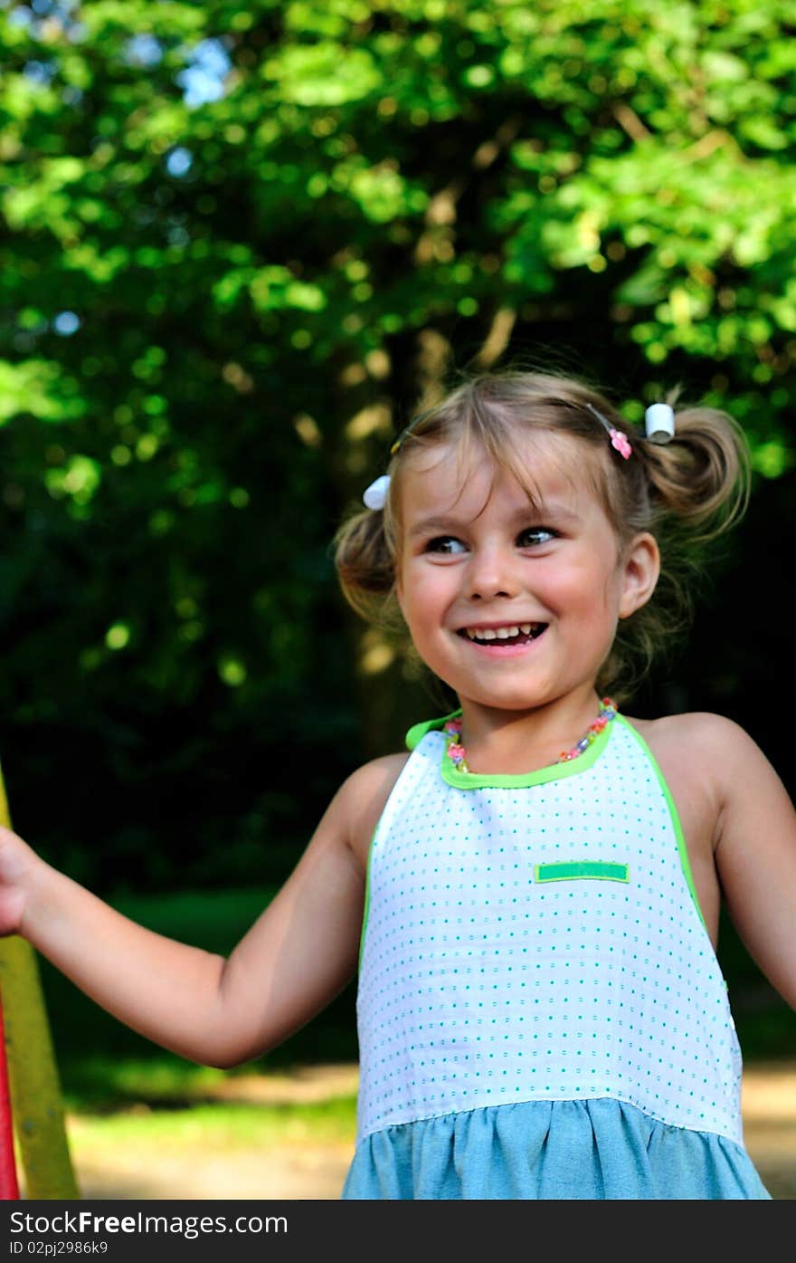 Little girl playing in the green park. Little girl playing in the green park