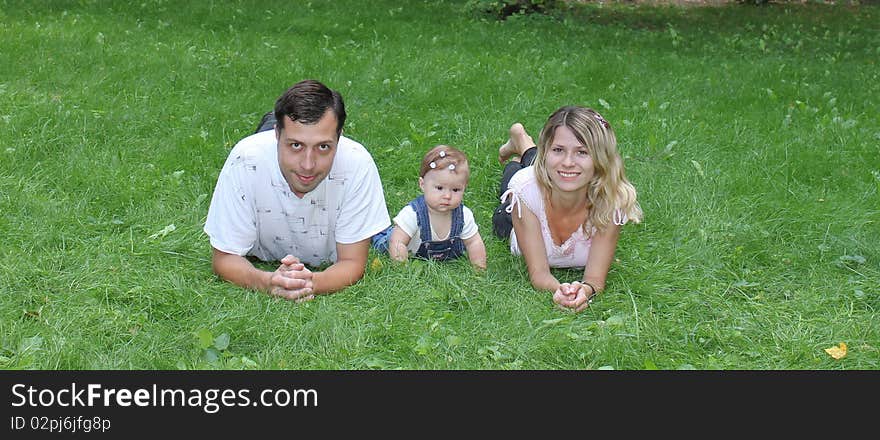 Young family on the green grass