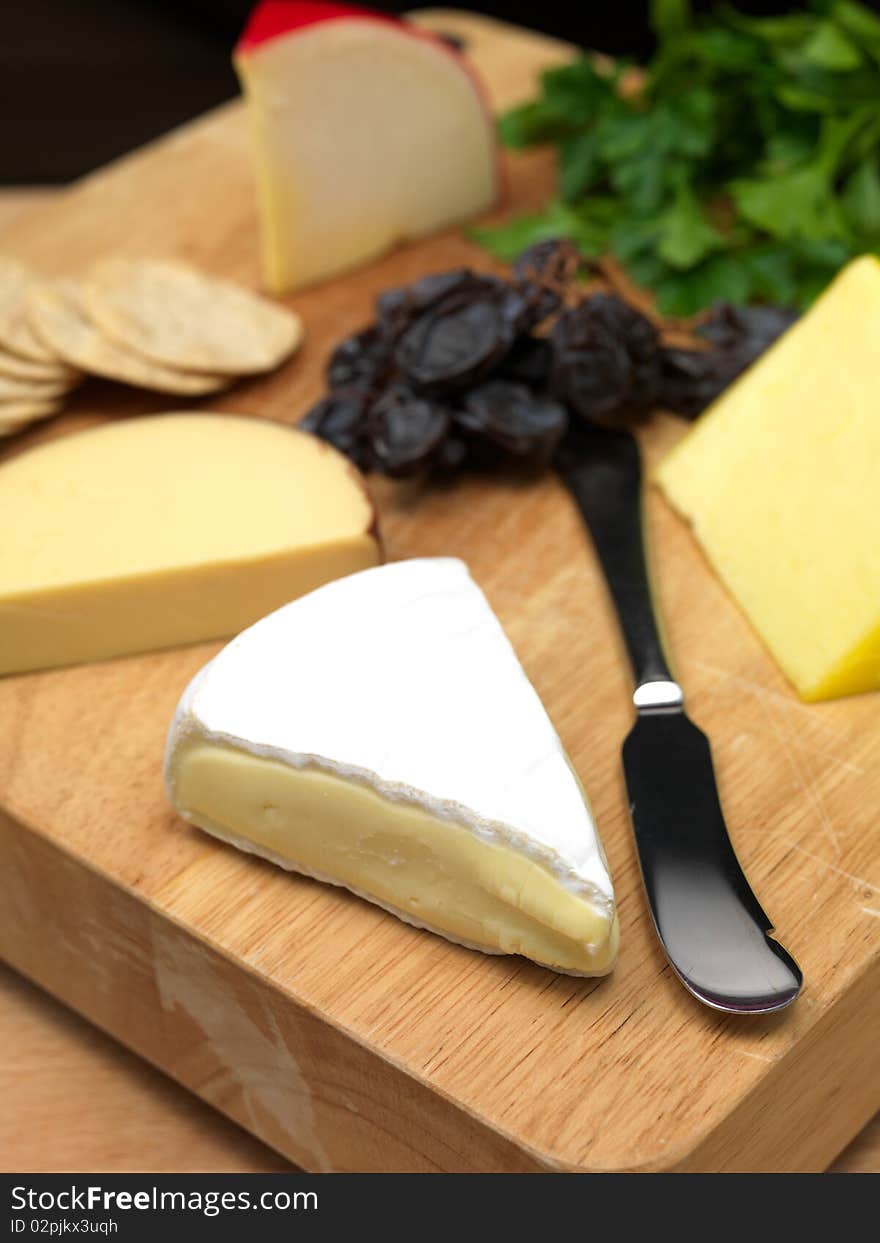 A selection of cheeses on a cutting board. A selection of cheeses on a cutting board