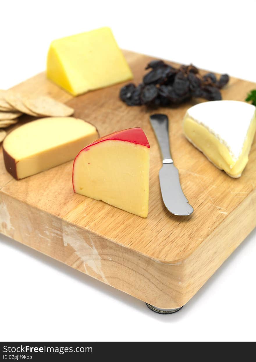 A selection of cheeses on a cutting board. A selection of cheeses on a cutting board