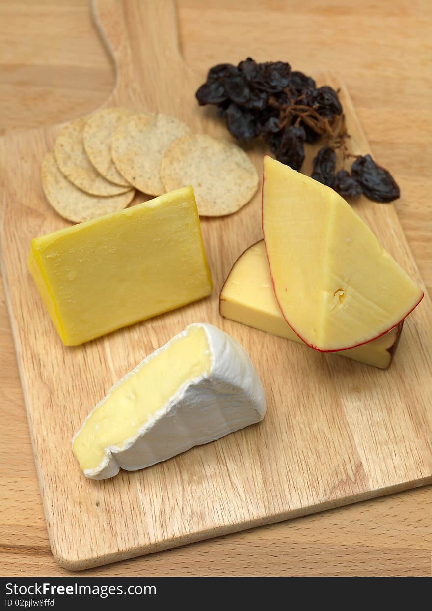 A selection of cheeses on a cutting board. A selection of cheeses on a cutting board