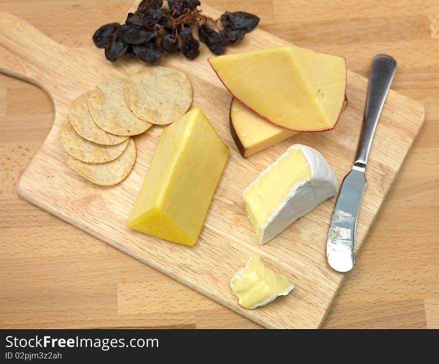 A selection of cheeses on a cutting board. A selection of cheeses on a cutting board