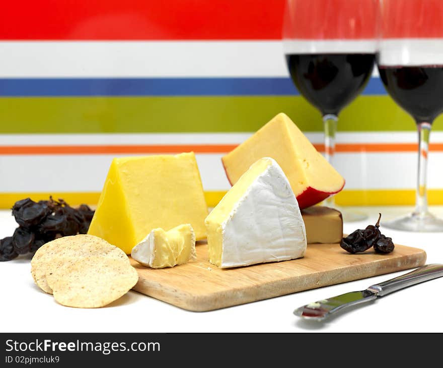 A selection of cheeses on a cutting board. A selection of cheeses on a cutting board