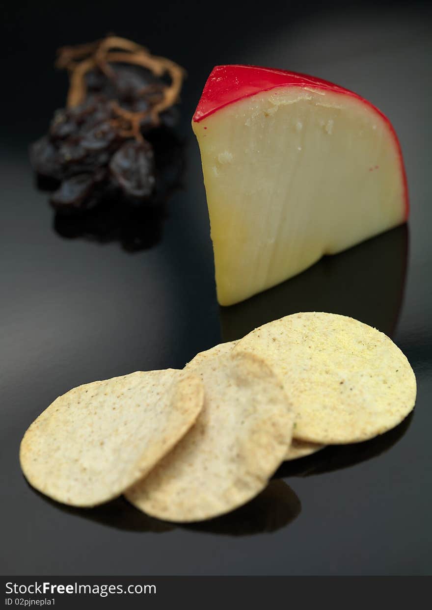 Gouda cheese isolated on against a black background