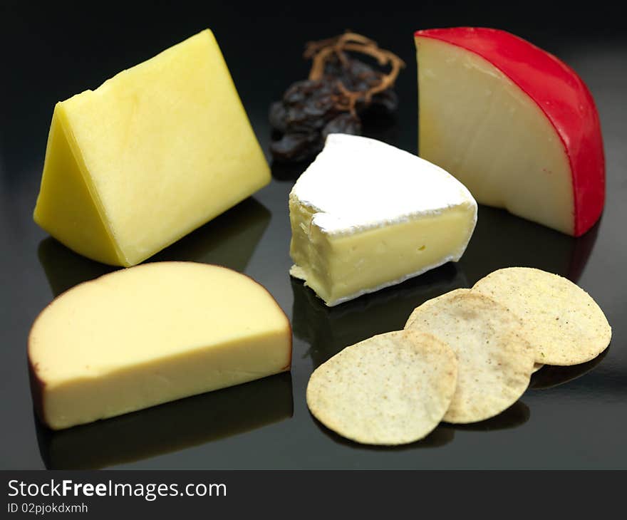 A selection of cheeses a black background. A selection of cheeses a black background