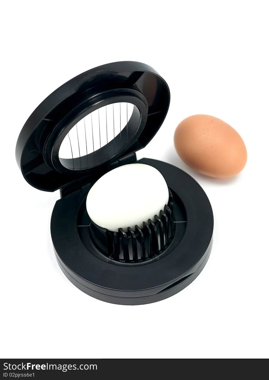 An egg slicer isolated against a white background