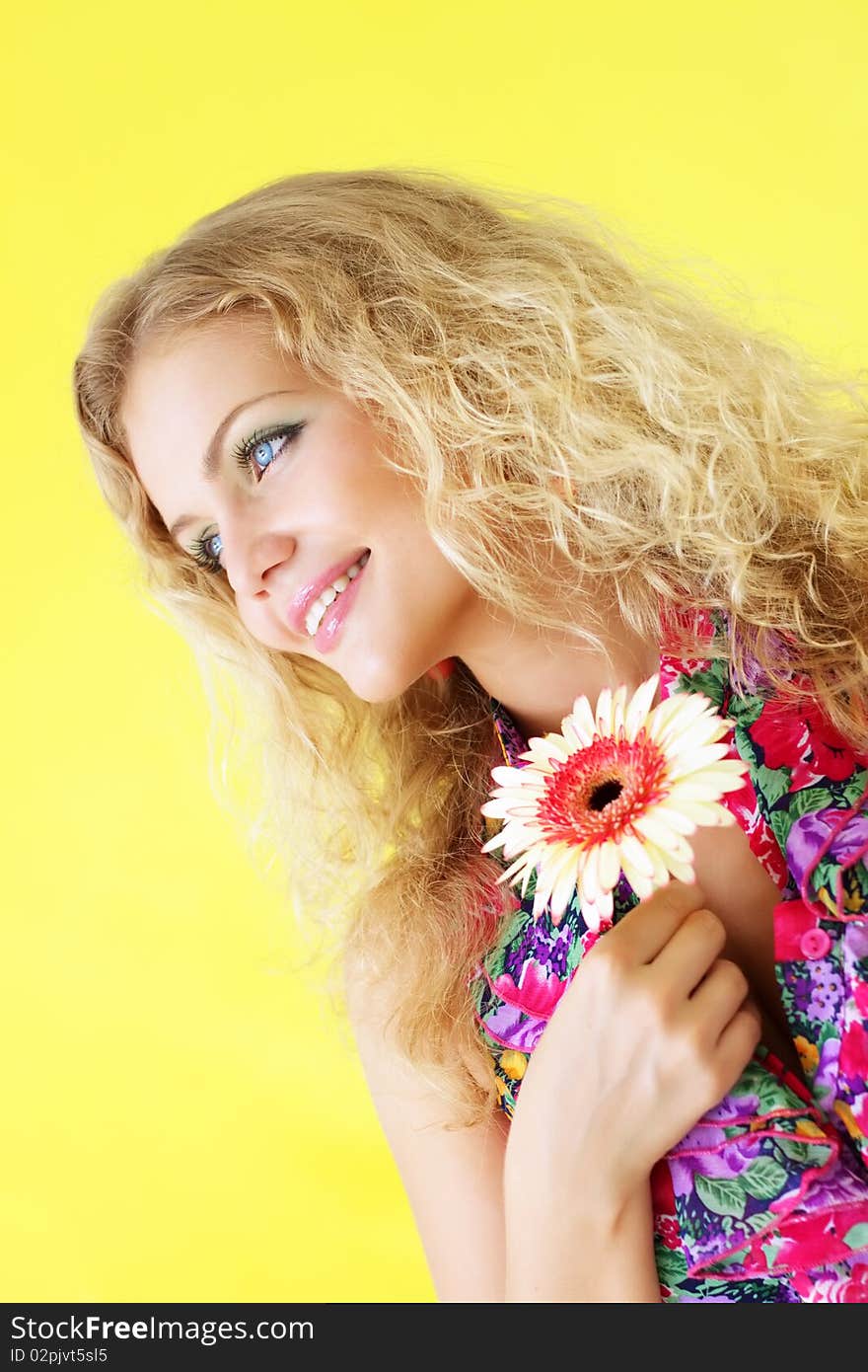 Beautiful girl and gerbera on a light background