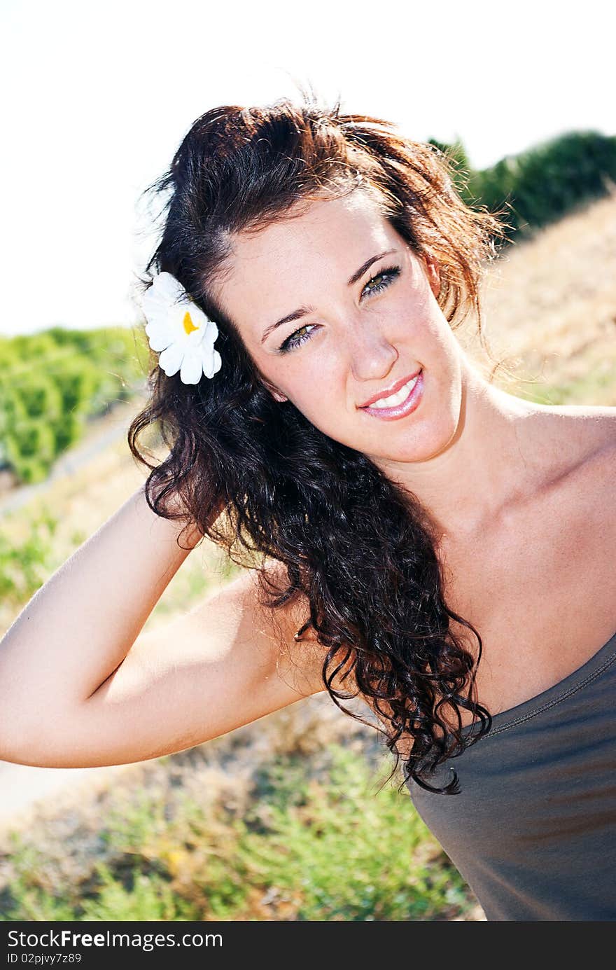 Sensual young girl with light skin and dark hair posing on white background