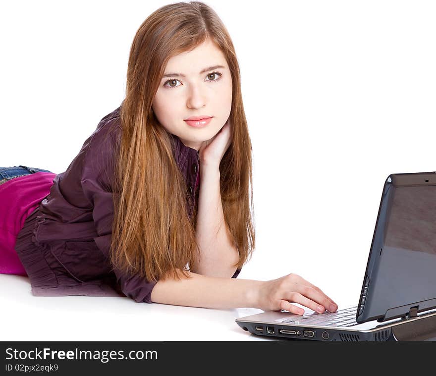 Girl on a floor with laptop. Isolated on white background