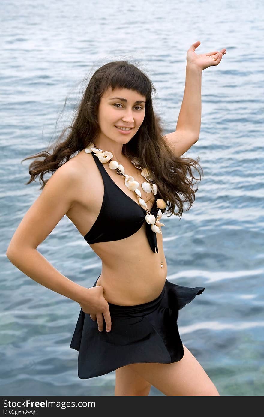 Pretty girl with seahell beads standing  near the sea. Pretty girl with seahell beads standing  near the sea