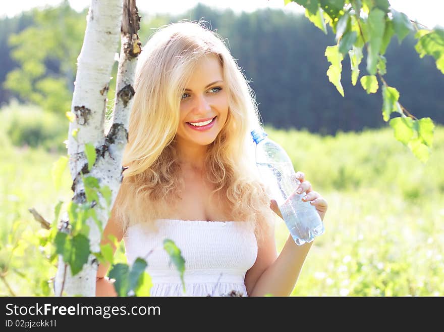 Beautiful girl holding a bottle of water