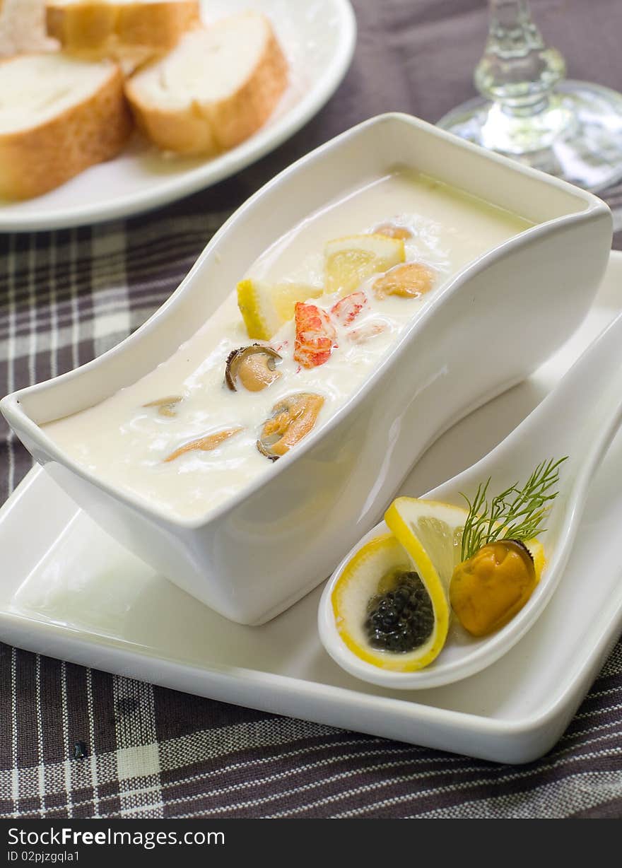 A bowl of cheese cream soup with shrimps and mussels. A bowl of cheese cream soup with shrimps and mussels