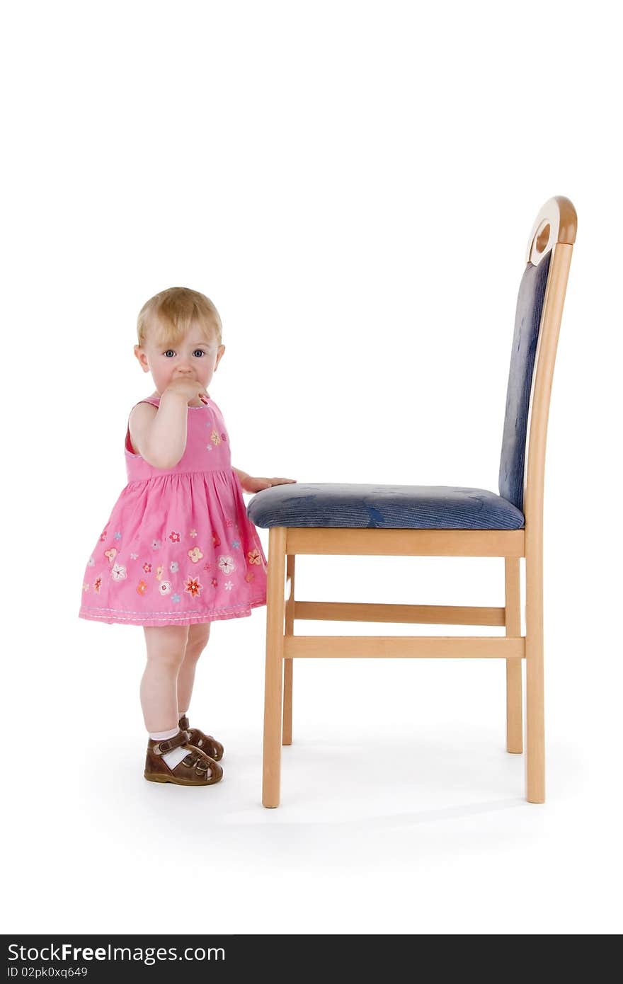 Infant with chair on white background.