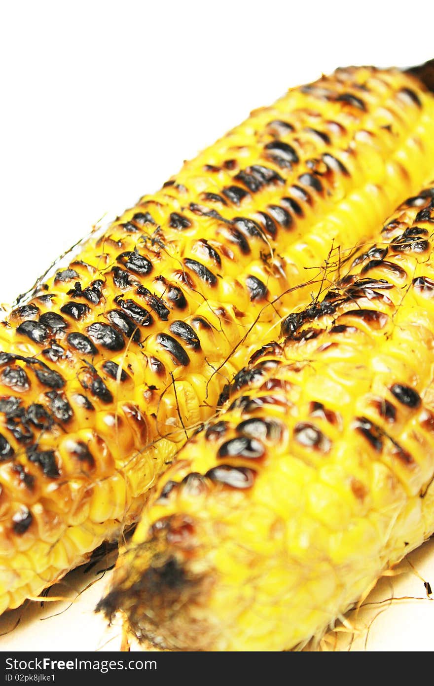 Two newly grilled corn on white background.