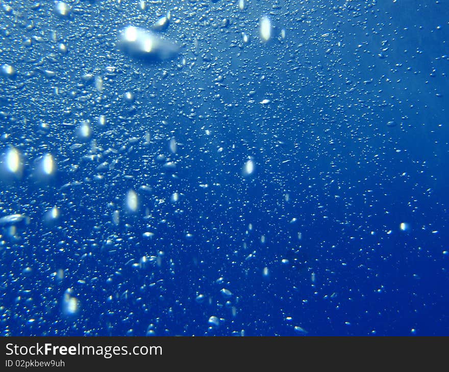 Blue underwater background with water air bubbles