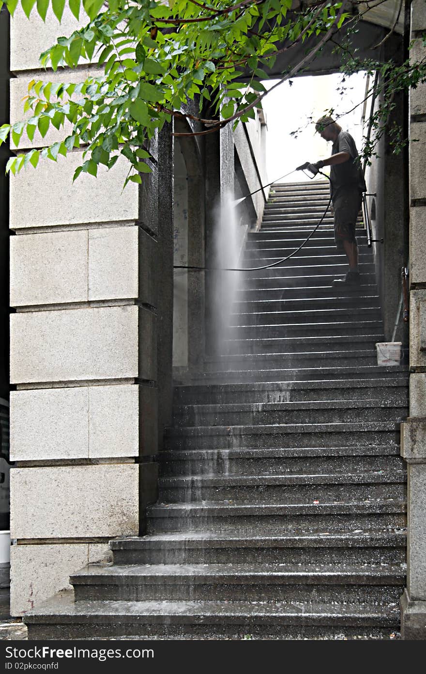 Washerman washes ladder on a bridge in Prague. Washerman washes ladder on a bridge in Prague