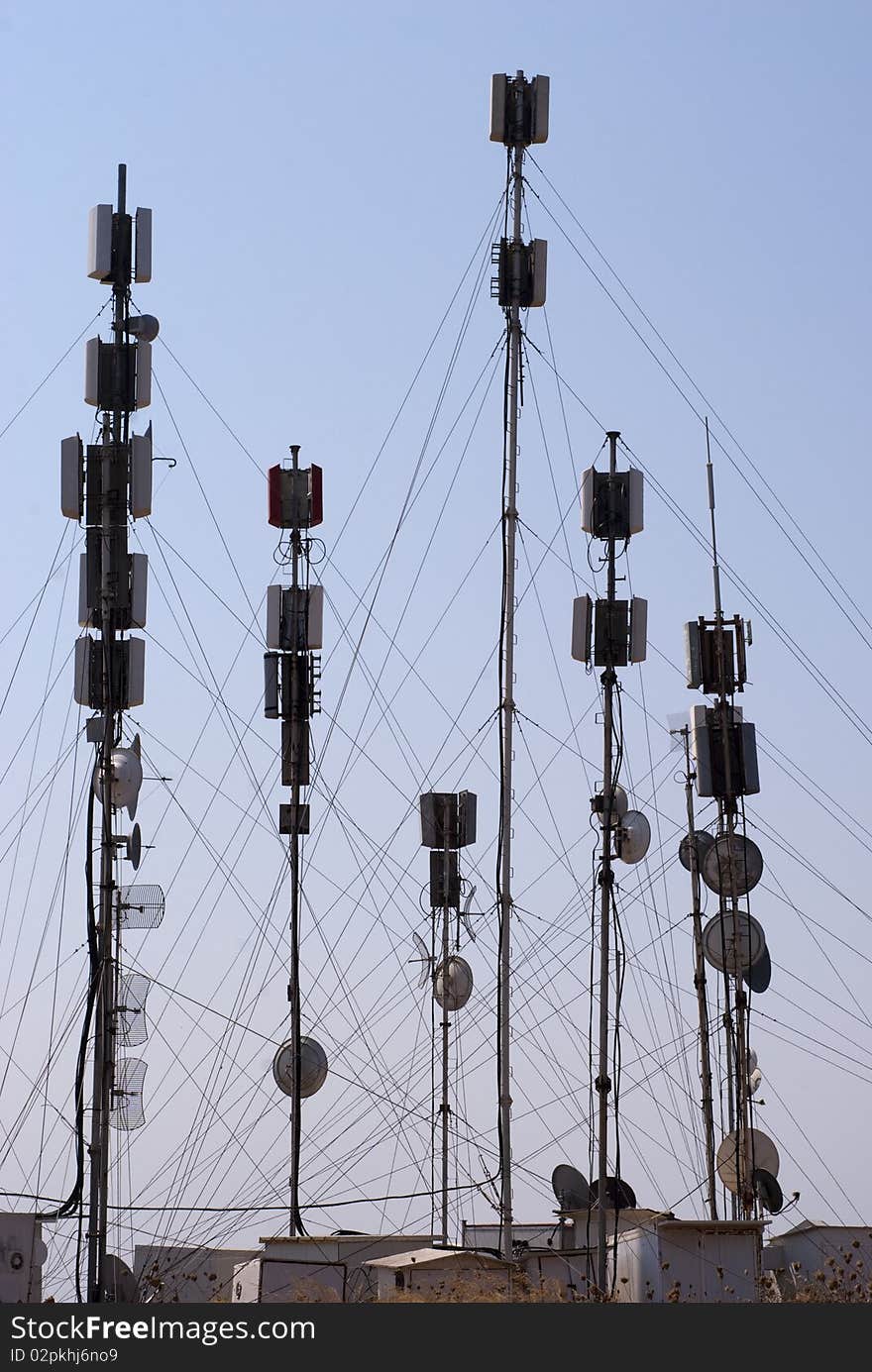 Various types of communication towers high up and sky blue. Various types of communication towers high up and sky blue.