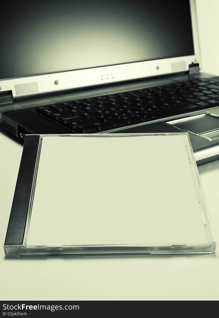 Blank cd case on notebook. Blank cd case on notebook.