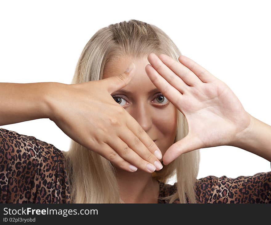 Pretty blonde girl looking through a frame made by her hands; isolated on white. Pretty blonde girl looking through a frame made by her hands; isolated on white