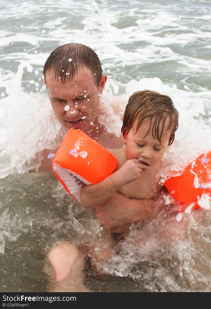 Father and son bathing in the sea