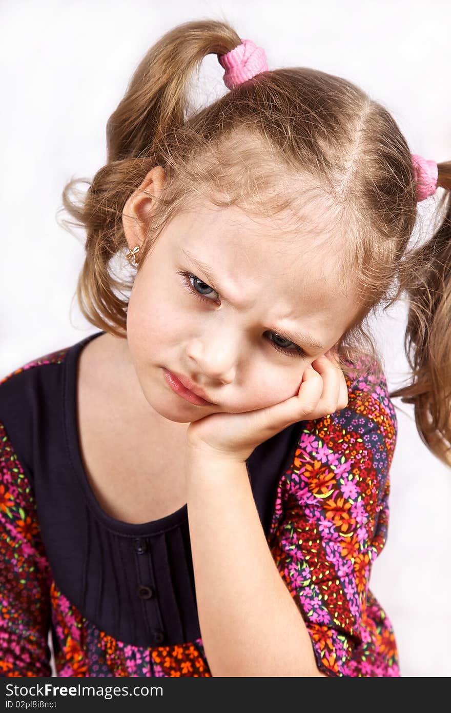 Close-up portrait of a cute serious thinkin little girl isolated on white background. Close-up portrait of a cute serious thinkin little girl isolated on white background