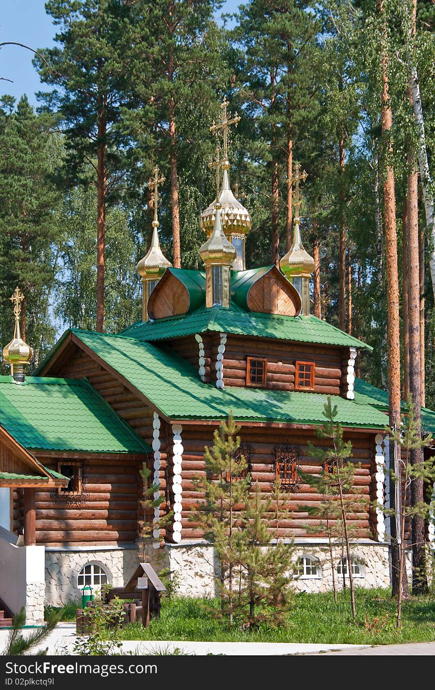 Wooden orthodox church among the pine trees in Russia, Urals. Wooden orthodox church among the pine trees in Russia, Urals