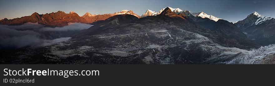 A panoramic perspective of the  Kanchenjunga Range captured during an early sunrise from a vantage point from Dzongri in Sikkim, India. A panoramic perspective of the  Kanchenjunga Range captured during an early sunrise from a vantage point from Dzongri in Sikkim, India.