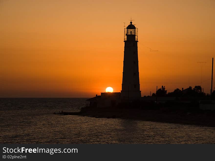 Bright sea sunset above the beacon