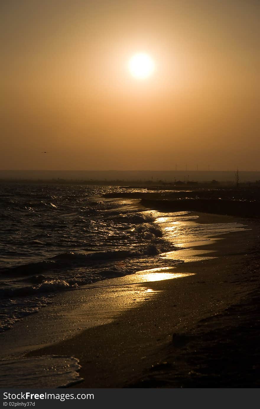 Bright sea sunset above the beach