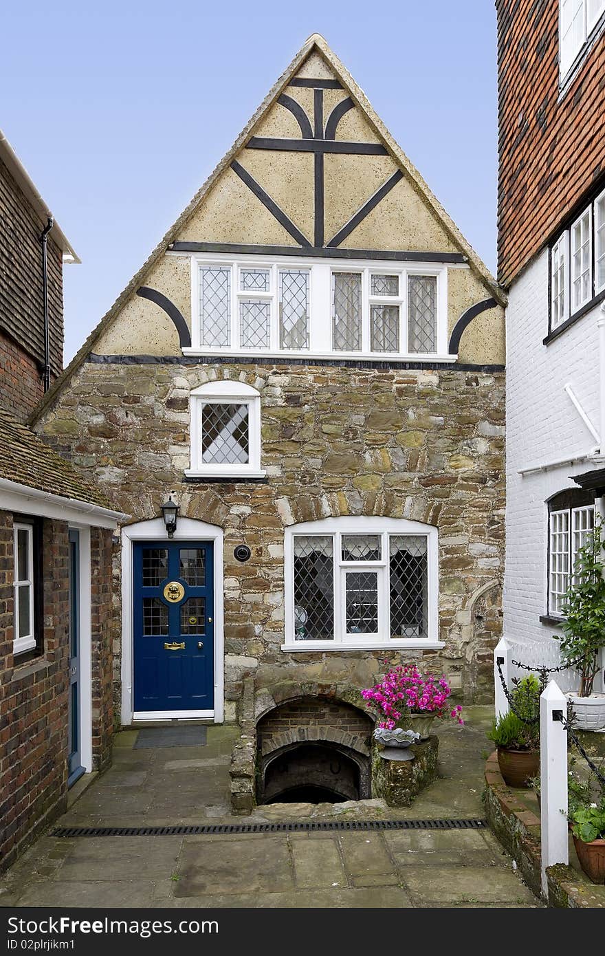 View of a quaint old house in England, with stairs leading down to a cellar. View of a quaint old house in England, with stairs leading down to a cellar