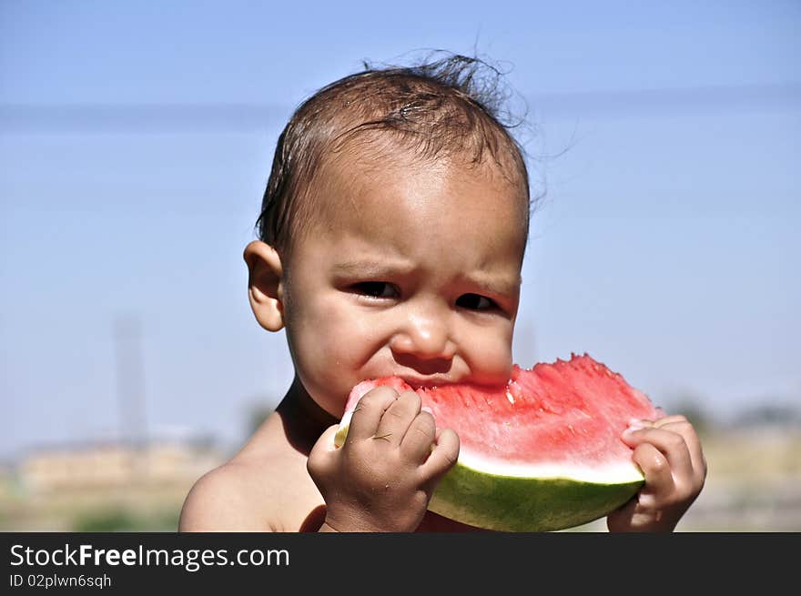 Little boy eating watermelon